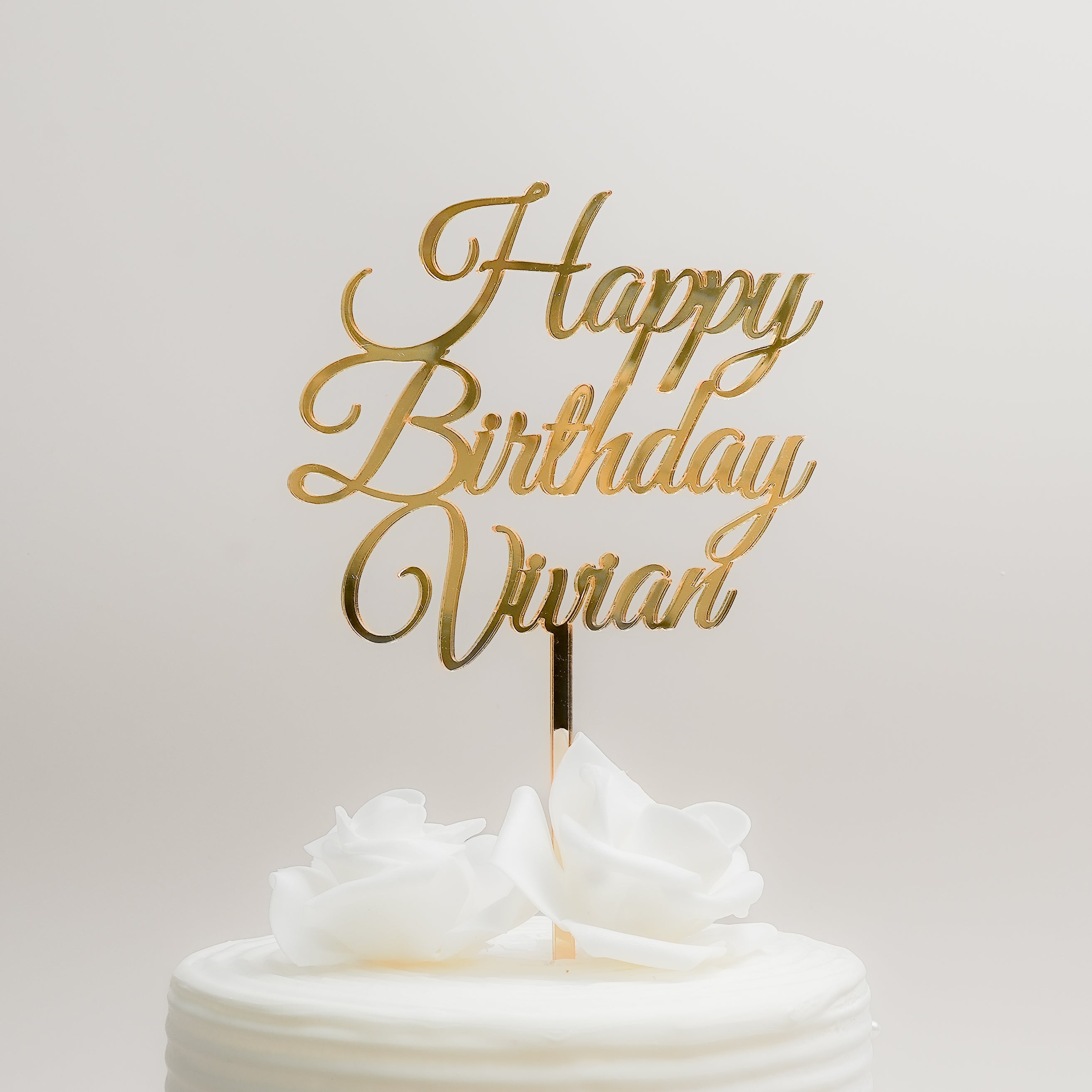 Original RIS product photograph: gold mirror acrylic Happy Birthday Vivian topper on a white cake